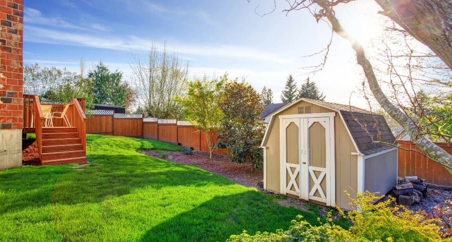 Fenced backyard with storage shed in Huntsville